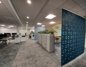 Photograph of office retrofit showing lockers, adjustable desks and sound baffles